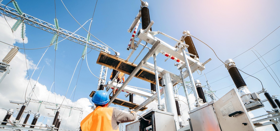 Adult electrical engineer inspect the electrical systems at the equipment control cabinet. Installation of modern electrical station