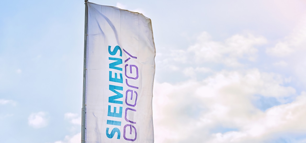 Siemens Energy flag waving in the wind against the blue sky.